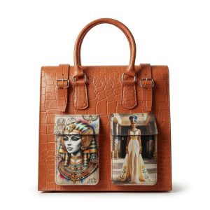 Structured orange crocodile-embossed handbag on a wooden table, featuring dual front pockets with colorful prints of an Egyptian queen in a luxurious interior.